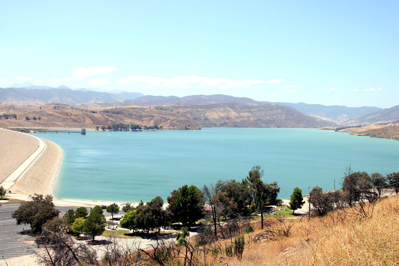 Castaic Lake State Recreation Area with dam, blue water, and surrounding mountains near Los Angeles
