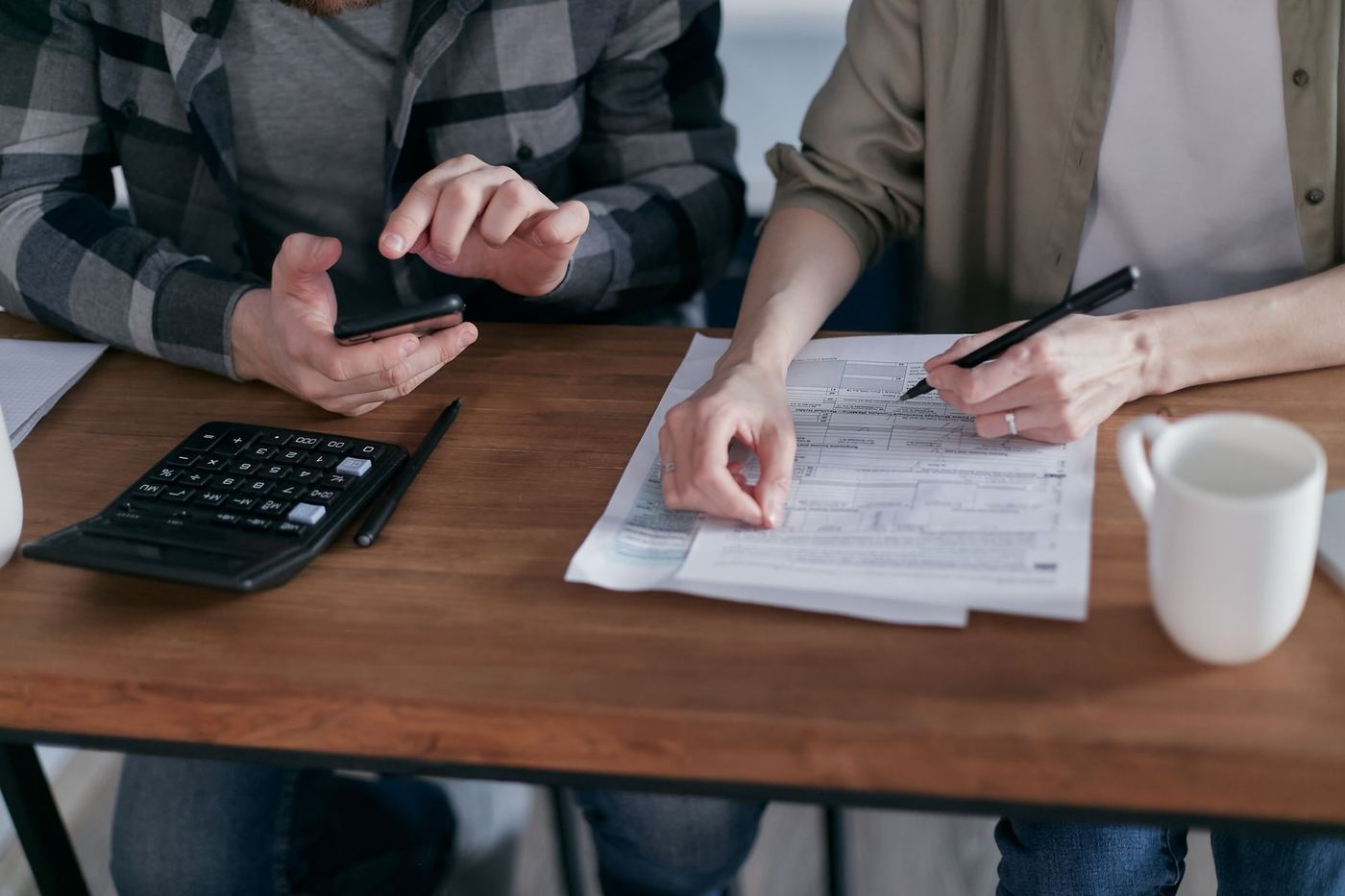 Couple reviewing property tax and capital gains paperwork before downsizing in Santa Clarita