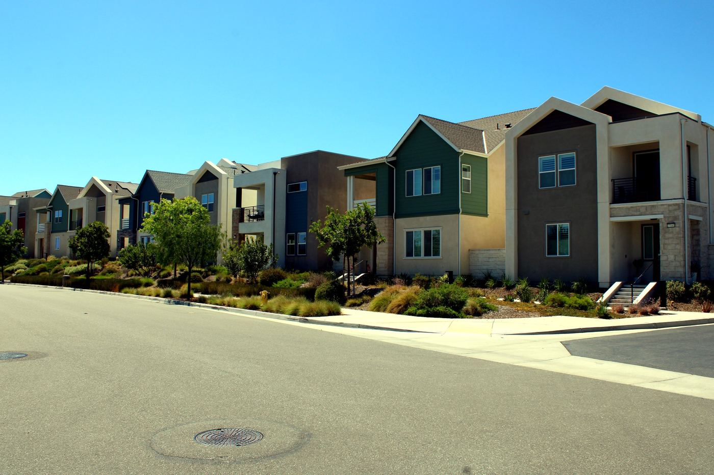 Row of modern two-story homes on a tree-lined street in the FivePoint neighborhood of Valencia, Santa Clarita