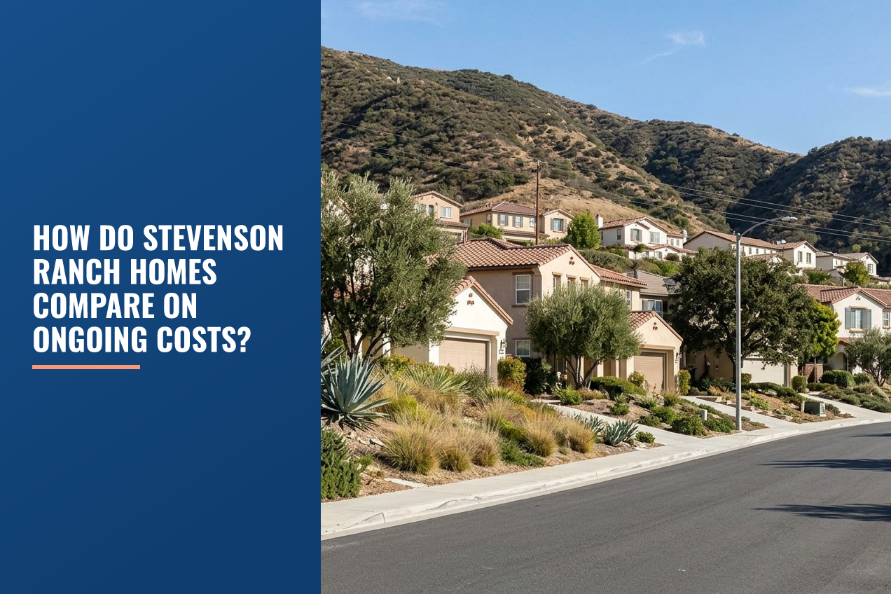 A street scene in Stevenson Ranch, CA with Mediterranean-style houses, drought-tolerant landscaping, and foothills under a clear blue sky.