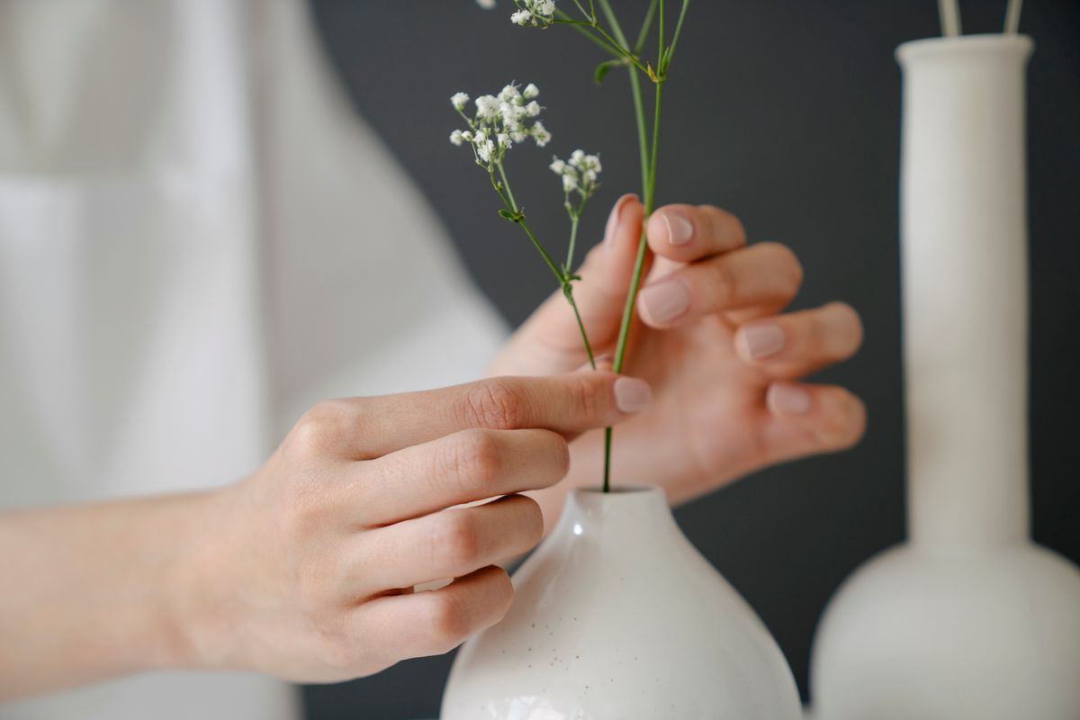 Hands arranging flowers while staging a Newhall home for sale, Santa Clarita