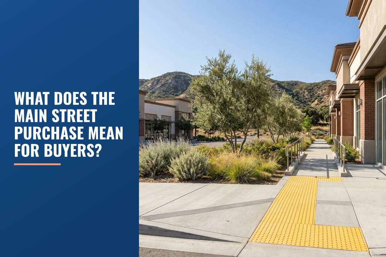 A commercial building exterior with drought-tolerant landscaping and nearby foothills under a clear sky.