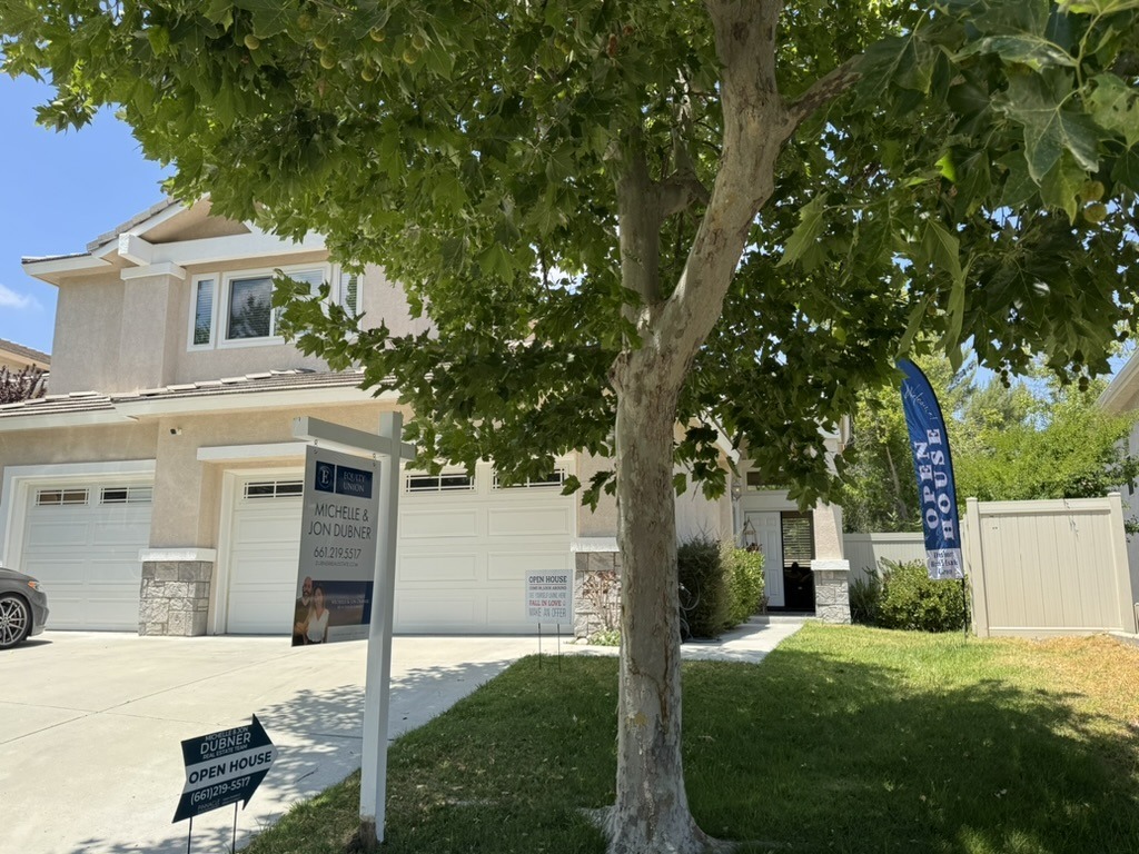 A Dubner Real Estate open house sign in front of a home